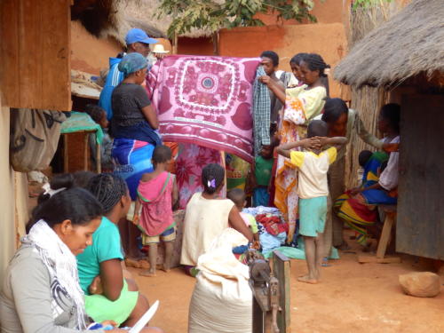 Madagascar - village de Tsaranoro, jour de vaccination des troupeaux, un marchand de tissus ambulant en profite
